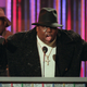 Notorious B.I.G., who won rap artist and rap single of the year, clutches his awards at the podium during the Billboard Music Awards in New York, on evening, Dec. 6, 1995.